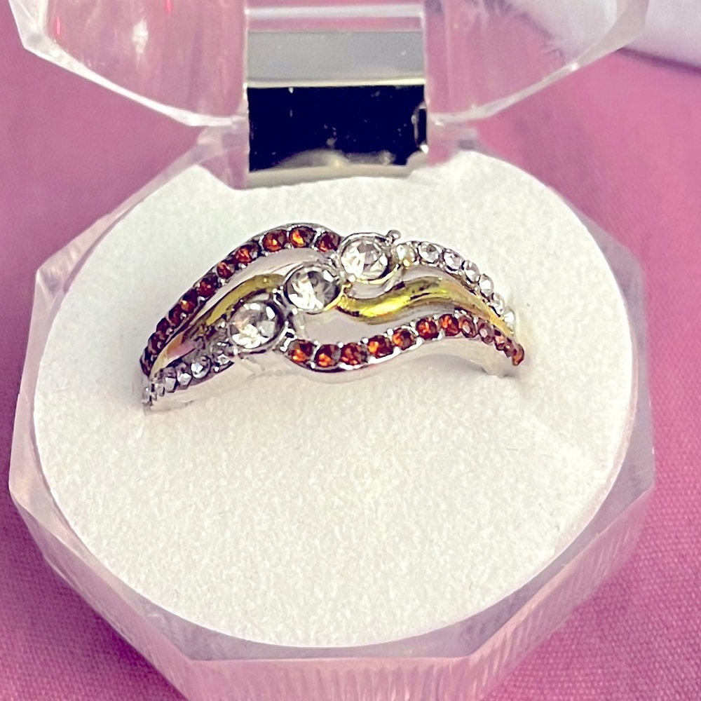 Silver and rose gold ring with gems.